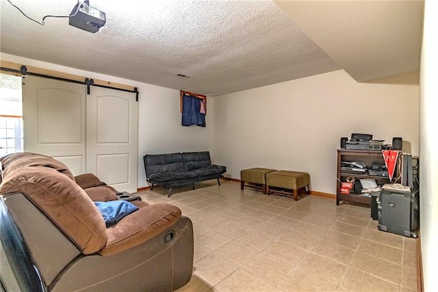 198 SE 455th Rd, Warrensburg, MO 64093 - living room with a textured ceiling, a barn door, and light tile patterned flooring