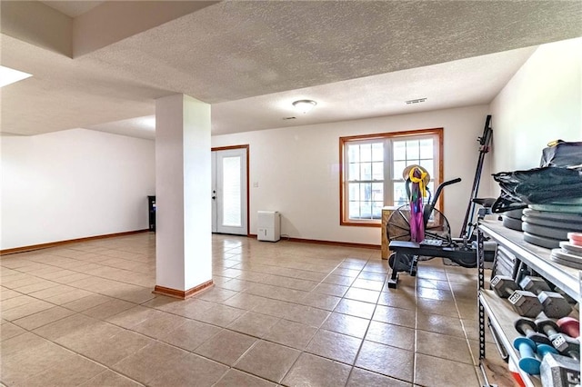 198 SE 455th Rd, Warrensburg, MO 64093 - workout room featuring tile patterned flooring and a textured ceiling