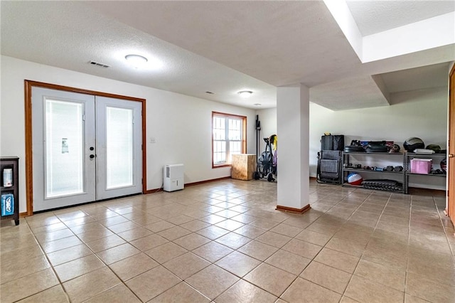 198 SE 455th Rd, Warrensburg, MO 64093 - basement featuring light tile patterned floors, french doors, and a textured ceiling