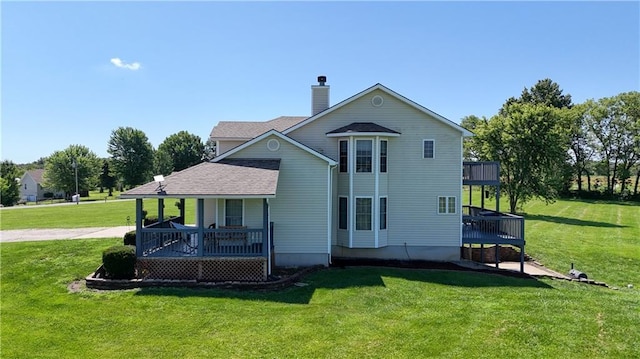 198 SE 455th Rd, Warrensburg, MO 64093 - rear view of property with a yard, covered porch, a chimney, and roof with shingles