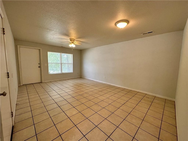 2804 Wenzel Ave, Kansas City, MO 64128 - unfurnished room featuring a textured ceiling, ceiling fan, and light tile patterned flooring