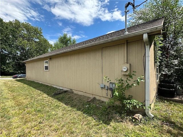 2804 Wenzel Ave, Kansas City, MO 64128 - view of side of home featuring a yard and roof with shingles