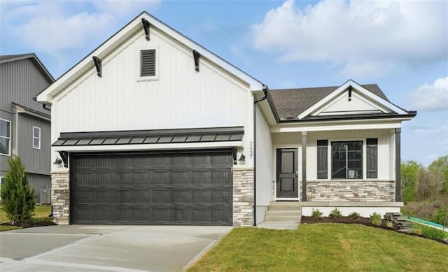 12508 S Parkwood Ln, Lees Summit, MO 64086 - view of front of home featuring stone siding, a standing seam roof, an attached garage, driveway, and a front yard