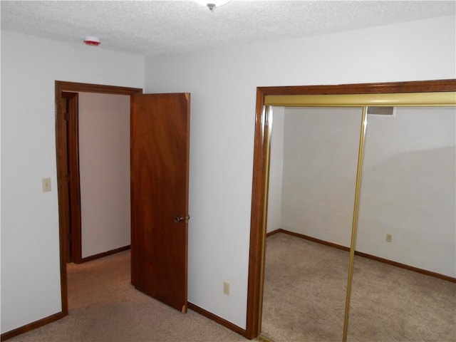 1019 N Kiger Rd, Independence, MO 64050 - unfurnished bedroom with carpet floors, a closet, and a textured ceiling
