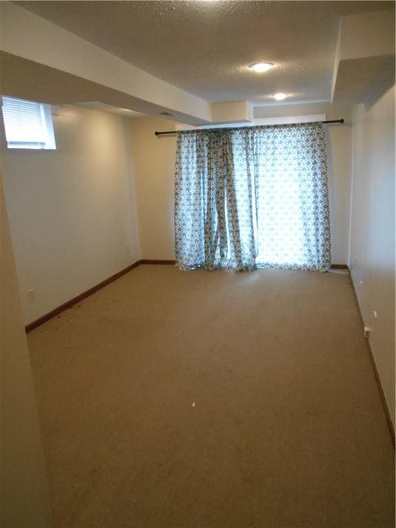 1019 N Kiger Rd, Independence, MO 64050 - empty room featuring carpet flooring and a textured ceiling