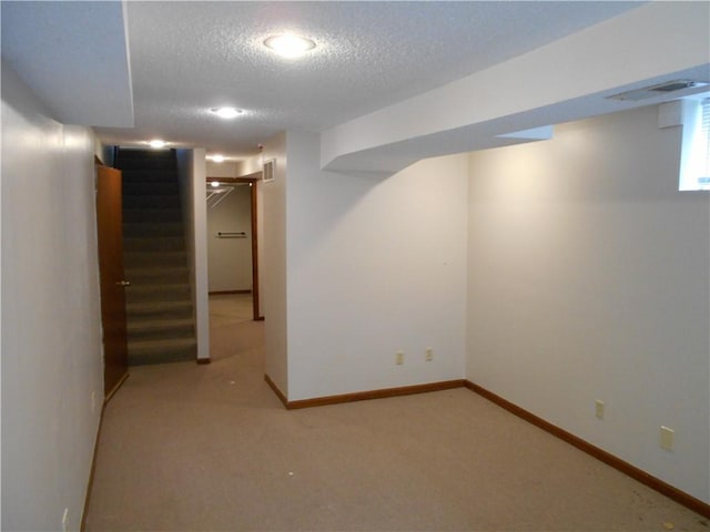 1019 N Kiger Rd, Independence, MO 64050 - basement featuring a textured ceiling, light carpet, and stairway