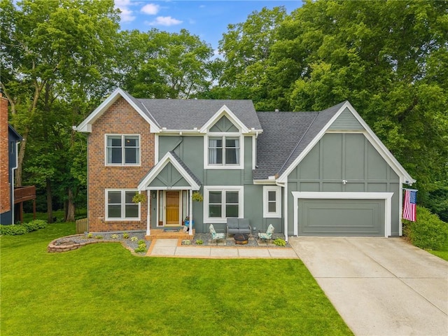617 Butternut Ln, Liberty, MO 64068 - view of front of house featuring concrete driveway, a garage, a front yard, board and batten siding, and a shingled roof