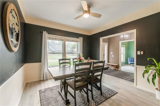 617 Butternut Ln, Liberty, MO 64068 - dining space featuring plenty of natural light, light wood-style flooring, a ceiling fan, a chandelier, and ornamental molding
