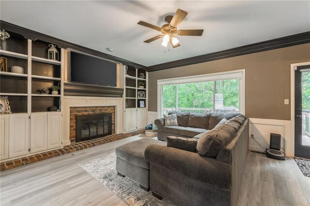 617 Butternut Ln, Liberty, MO 64068 - living room with crown molding, ceiling fan, light wood finished floors, healthy amount of natural light, and a wainscoted wall