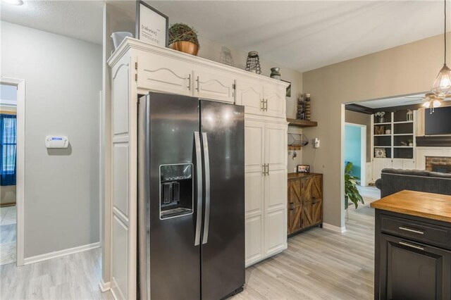 617 Butternut Ln, Liberty, MO 64068 - kitchen with stainless steel fridge with ice dispenser, white cabinets, light wood-type flooring, and ceiling fan