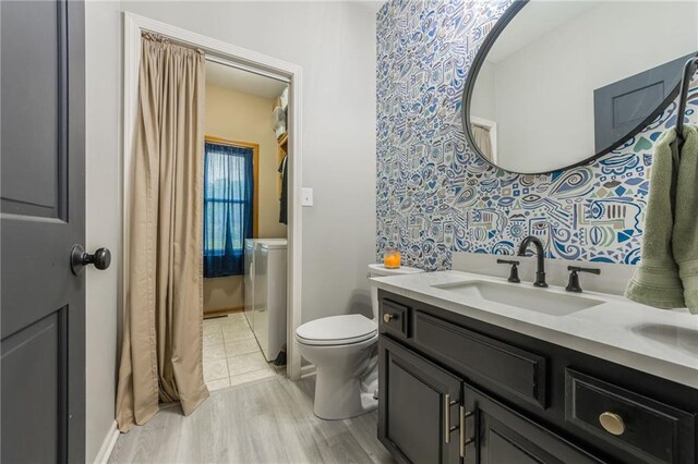 617 Butternut Ln, Liberty, MO 64068 - full bath featuring vanity, wood finished floors, and washer / clothes dryer