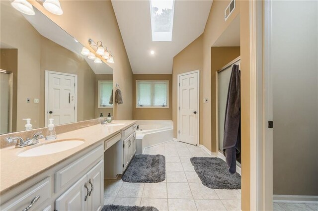 617 Butternut Ln, Liberty, MO 64068 - bathroom with a skylight, lofted ceiling, a shower stall, double vanity, and a garden tub