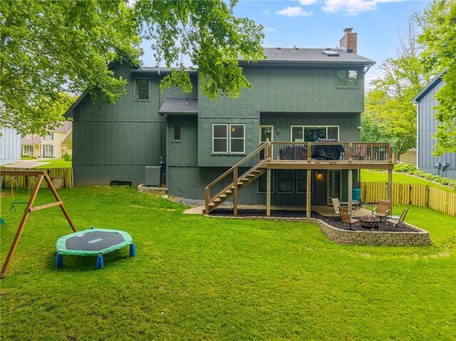 617 Butternut Ln, Liberty, MO 64068 - back of property featuring an outdoor fire pit, stairway, a deck, a fenced backyard, and a chimney