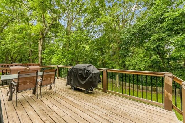 617 Butternut Ln, Liberty, MO 64068 - wooden terrace featuring outdoor dining space and a grill