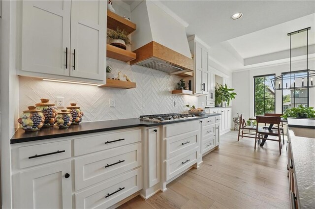 17316 Noland St, Overland Park, KS 66221 - kitchen with open shelves, custom range hood, stainless steel gas stovetop, backsplash, and recessed lighting