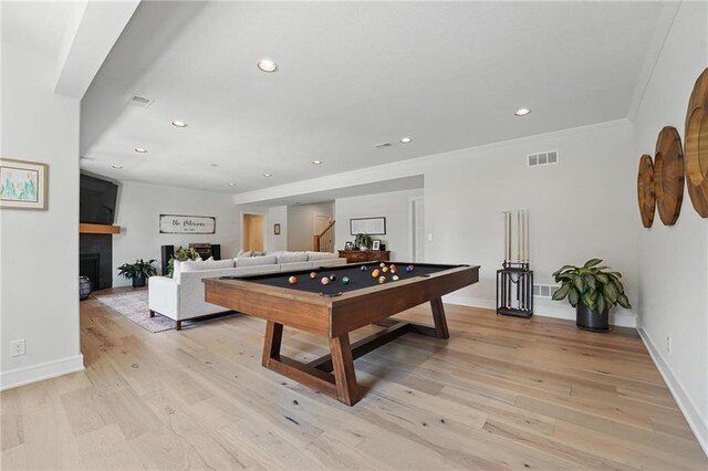 17316 Noland St, Overland Park, KS 66221 - playroom featuring recessed lighting, light wood-style floors, billiards table, a fireplace, and ornamental molding