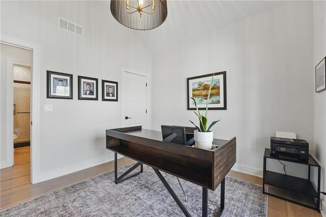 17316 Noland St, Overland Park, KS 66221 - office area featuring a high ceiling, wood finished floors, and a chandelier