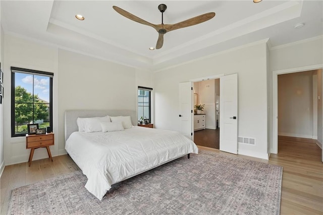 17316 Noland St, Overland Park, KS 66221 - bedroom featuring a tray ceiling, light wood-style floors, crown molding, recessed lighting, and ceiling fan