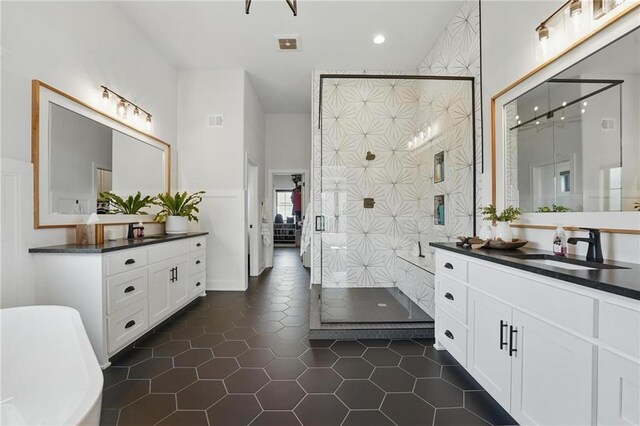 17316 Noland St, Overland Park, KS 66221 - bathroom with a shower stall, two vanities, a freestanding bath, tile patterned floors, and recessed lighting
