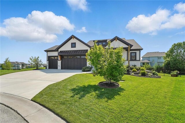 17316 Noland St, Overland Park, KS 66221 - view of front of home with an attached garage, driveway, a standing seam roof, and stone siding