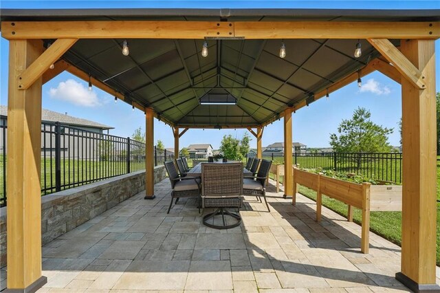 17316 Noland St, Overland Park, KS 66221 - fenced backyard featuring outdoor dining space, a gazebo, and a patio area