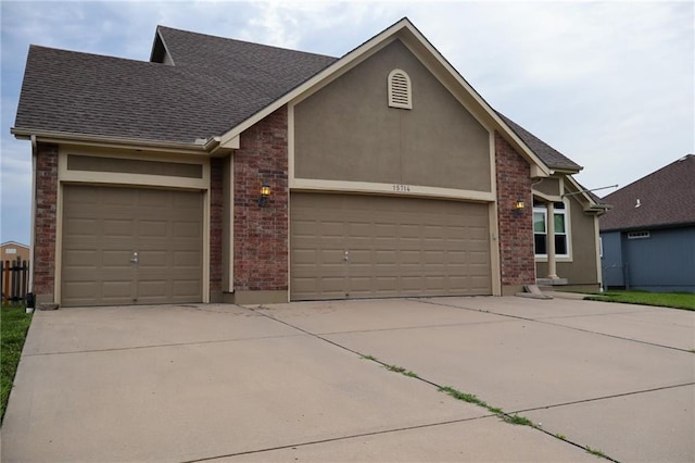 15714 Richmond Ave, Belton, MO 64012 - view of front of property with a garage, concrete driveway, and roof with shingles