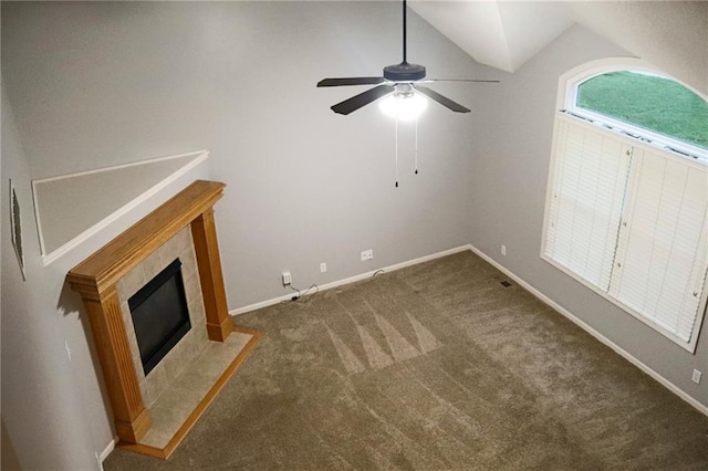 15714 Richmond Ave, Belton, MO 64012 - unfurnished living room featuring ceiling fan, lofted ceiling, carpet floors, and a tile fireplace