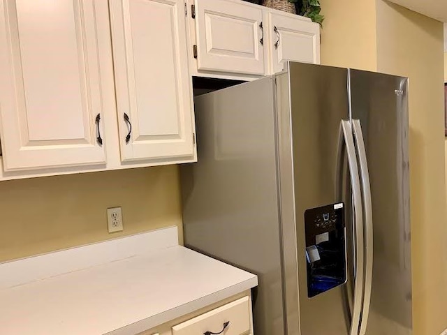 8806 W 106th Ter, Overland Park, KS 66212 - kitchen with stainless steel fridge with ice dispenser, white cabinetry, and light countertops
