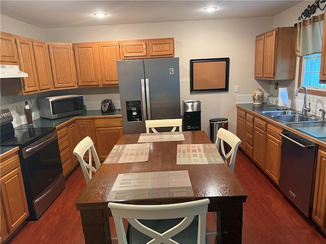 1003 S Ridgeway St, Caney, KS 67333 - kitchen featuring appliances with stainless steel finishes, extractor fan, dark wood-type flooring, recessed lighting, and dark countertops