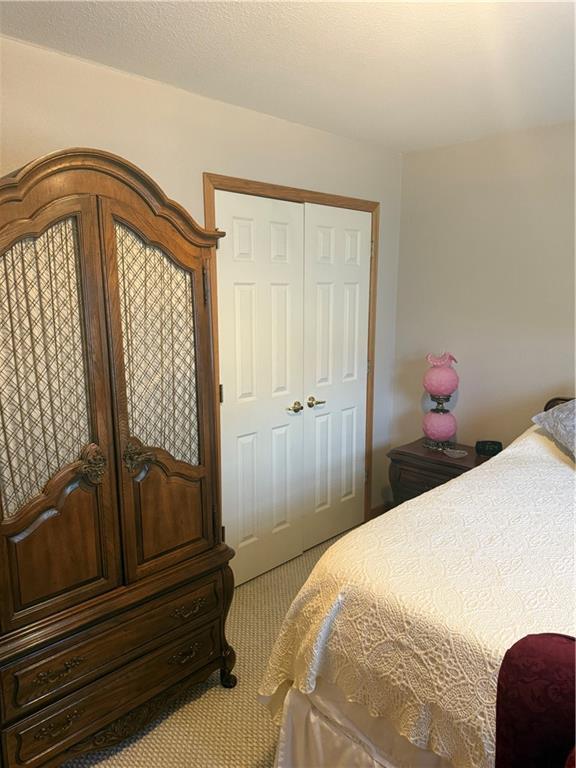 1003 S Ridgeway St, Caney, KS 67333 - carpeted bedroom with a closet
