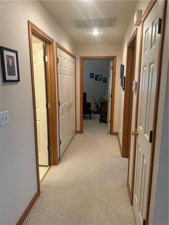 1003 S Ridgeway St, Caney, KS 67333 - hall featuring light colored carpet and baseboards