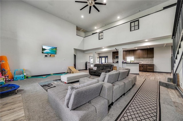 9414 Greenton Rd, Odessa, MO 64076 - living area featuring a ceiling fan, a high ceiling, and recessed lighting