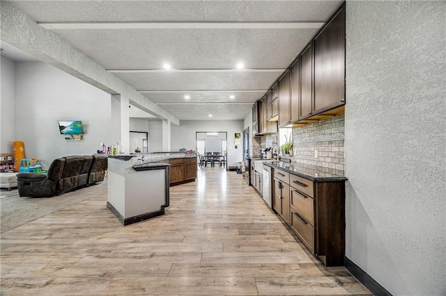 9414 Greenton Rd, Odessa, MO 64076 - kitchen featuring light wood finished floors, open floor plan, a textured wall, recessed lighting, and a textured ceiling