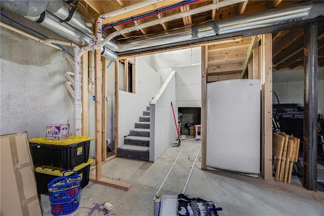 9414 Greenton Rd, Odessa, MO 64076 - unfinished basement featuring freestanding refrigerator and stairway
