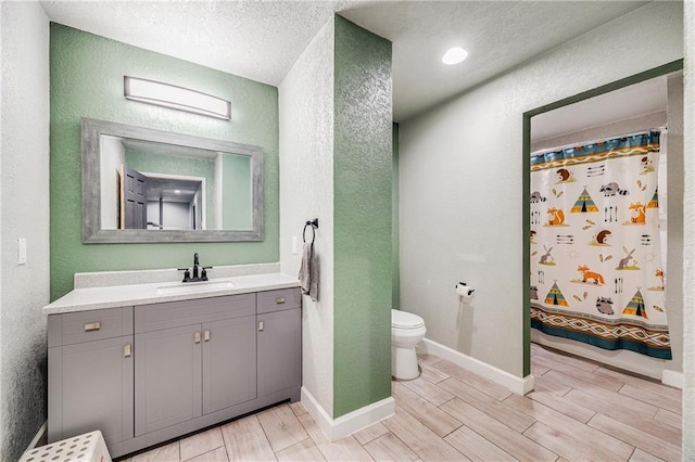 9414 Greenton Rd, Odessa, MO 64076 - full bathroom with a textured wall, wood tiled floors, vanity, a textured ceiling, and curtained shower