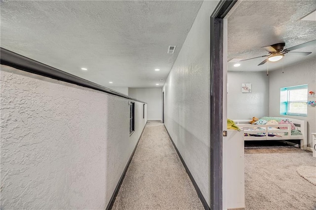 9414 Greenton Rd, Odessa, MO 64076 - corridor with a textured ceiling, a textured wall, light carpet, and recessed lighting