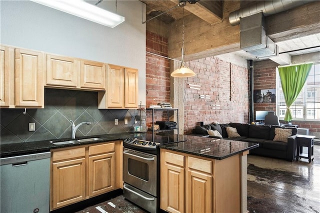321 W 7th St Unit 501, Kansas City, MO 64105 - kitchen with stainless steel appliances, a peninsula, decorative backsplash, open floor plan, and brick wall