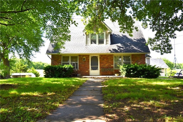 31212 E Webster Rd, Grain Valley, MO 64029 - cape cod home featuring a front yard and brick siding