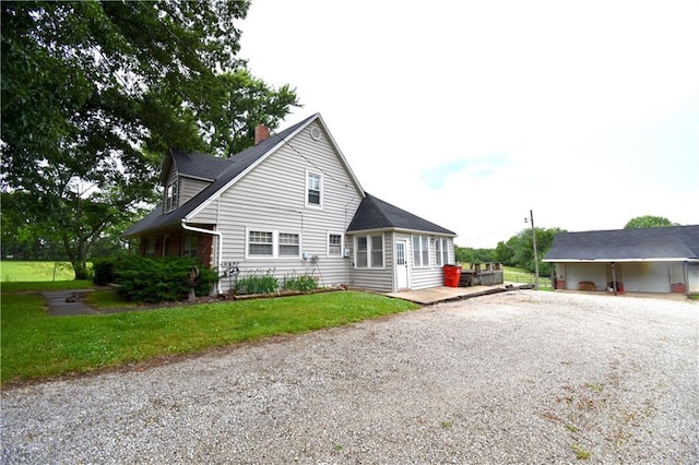 31212 E Webster Rd, Grain Valley, MO 64029 - view of property exterior featuring driveway and a chimney