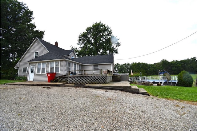 31212 E Webster Rd, Grain Valley, MO 64029 - view of front of house with a wooden deck and a chimney