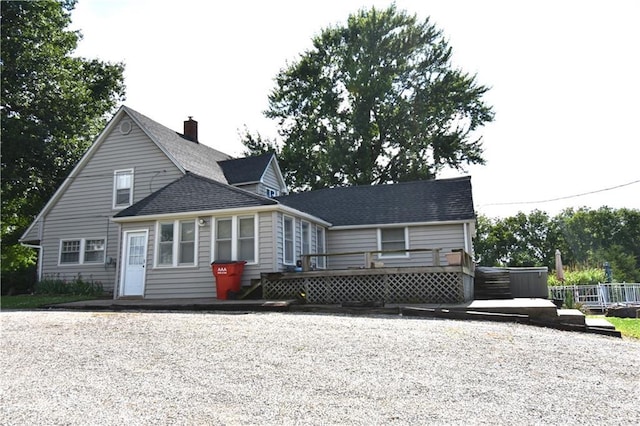 31212 E Webster Rd, Grain Valley, MO 64029 - back of property featuring a wooden deck, a shingled roof, and a chimney