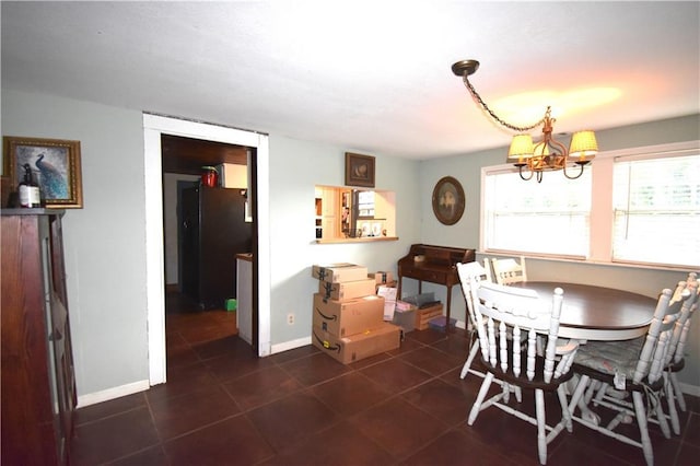 31212 E Webster Rd, Grain Valley, MO 64029 - dining space featuring a chandelier and dark tile patterned flooring