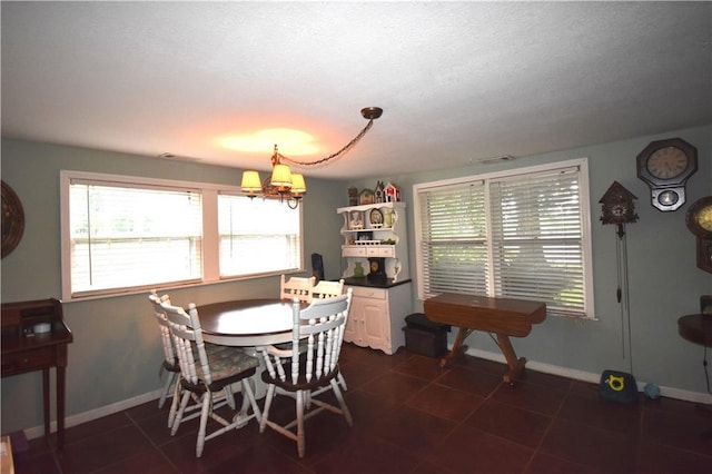31212 E Webster Rd, Grain Valley, MO 64029 - dining space with a chandelier, dark tile patterned flooring, and a textured ceiling