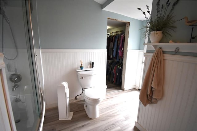 31212 E Webster Rd, Grain Valley, MO 64029 - full bathroom featuring a shower with door, a wainscoted wall, wood finished floors, and a spacious closet