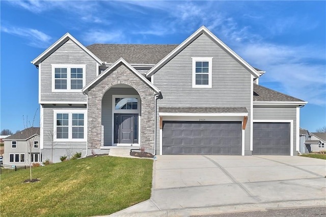 19787 W 114th Pl, Olathe, KS 66061 - traditional home with a front yard, driveway, stone siding, a garage, and an attached garage