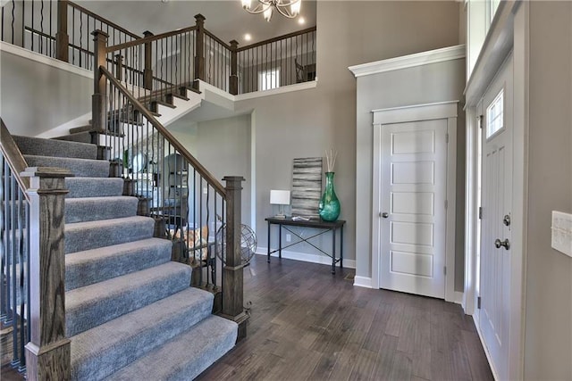 19787 W 114th Pl, Olathe, KS 66061 - entrance foyer with a towering ceiling, stairs, dark wood-type flooring, and a chandelier