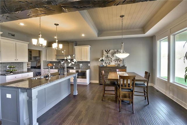 19787 W 114th Pl, Olathe, KS 66061 - kitchen featuring a raised ceiling, plenty of natural light, dark wood-type flooring, a chandelier, and crown molding