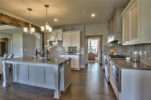 19787 W 114th Pl, Olathe, KS 66061 - kitchen featuring stainless steel appliances, dark stone counters, recessed lighting, tasteful backsplash, and white cabinets