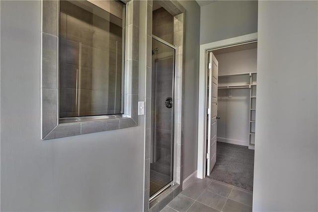 19787 W 114th Pl, Olathe, KS 66061 - full bathroom featuring a stall shower, a spacious closet, and tile patterned floors