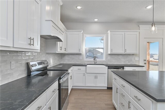 19422 W 114th Ter, Olathe, KS 66061 - kitchen featuring stainless steel appliances, white cabinets, healthy amount of natural light, decorative light fixtures, and recessed lighting